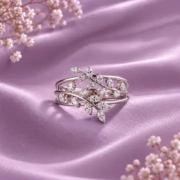 Women's silver ring with multiple clear stones on purple satin